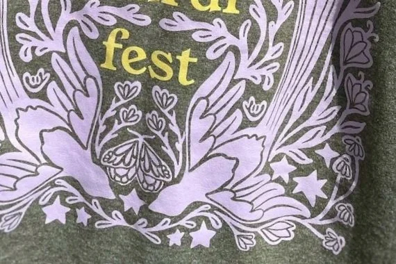 a close up on the front of the shirt showing the ILY handshape
