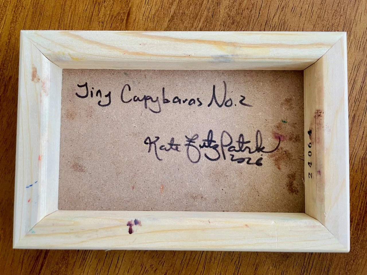 back of the cradled wood reads Tiny Capybaras no. 2 kate fitzpatrick 2026