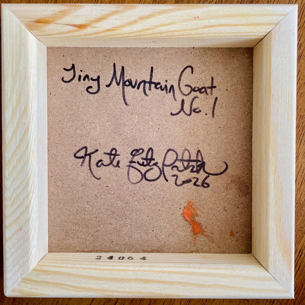 backside of the canvas with handwriting that reads tiny mountain goat no.1 kate fitzpatrick