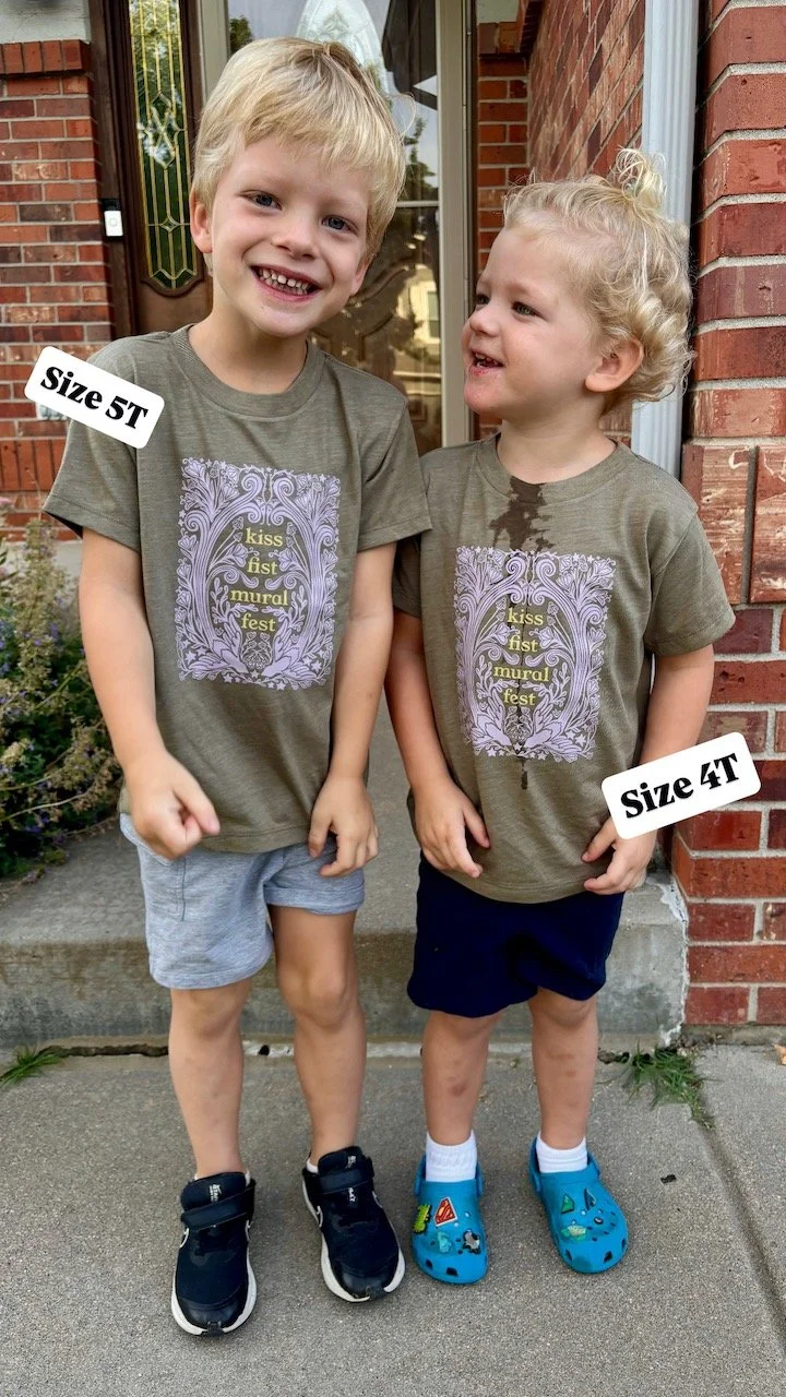 Two white toddlers smile at the camera. they wear matching shirts and text on screen indicates the size of each shirt - 4t and 5t.