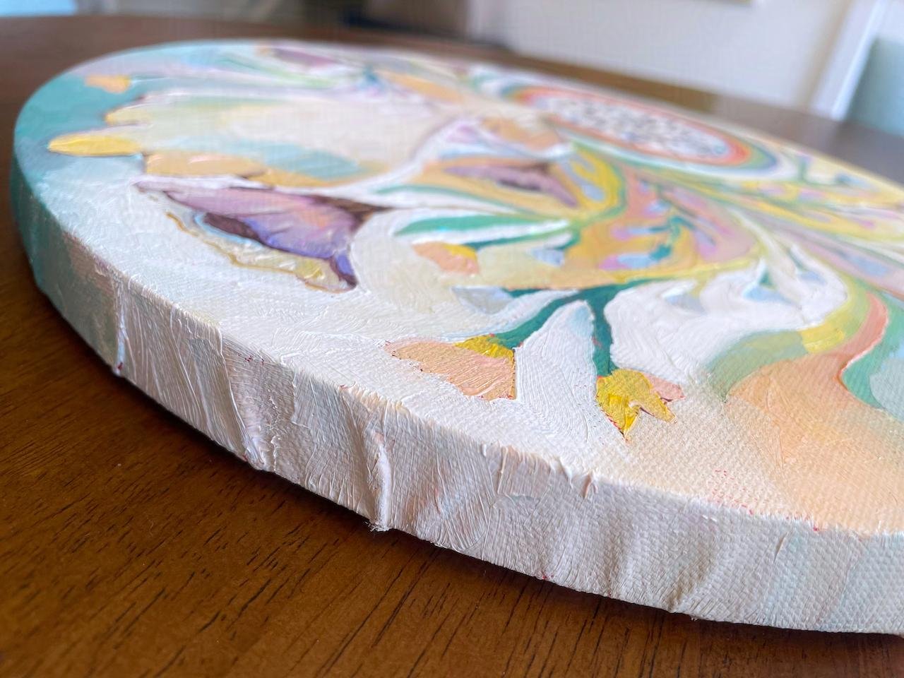 a side view of the painting showing that the paint continues onto the edges of the canvas