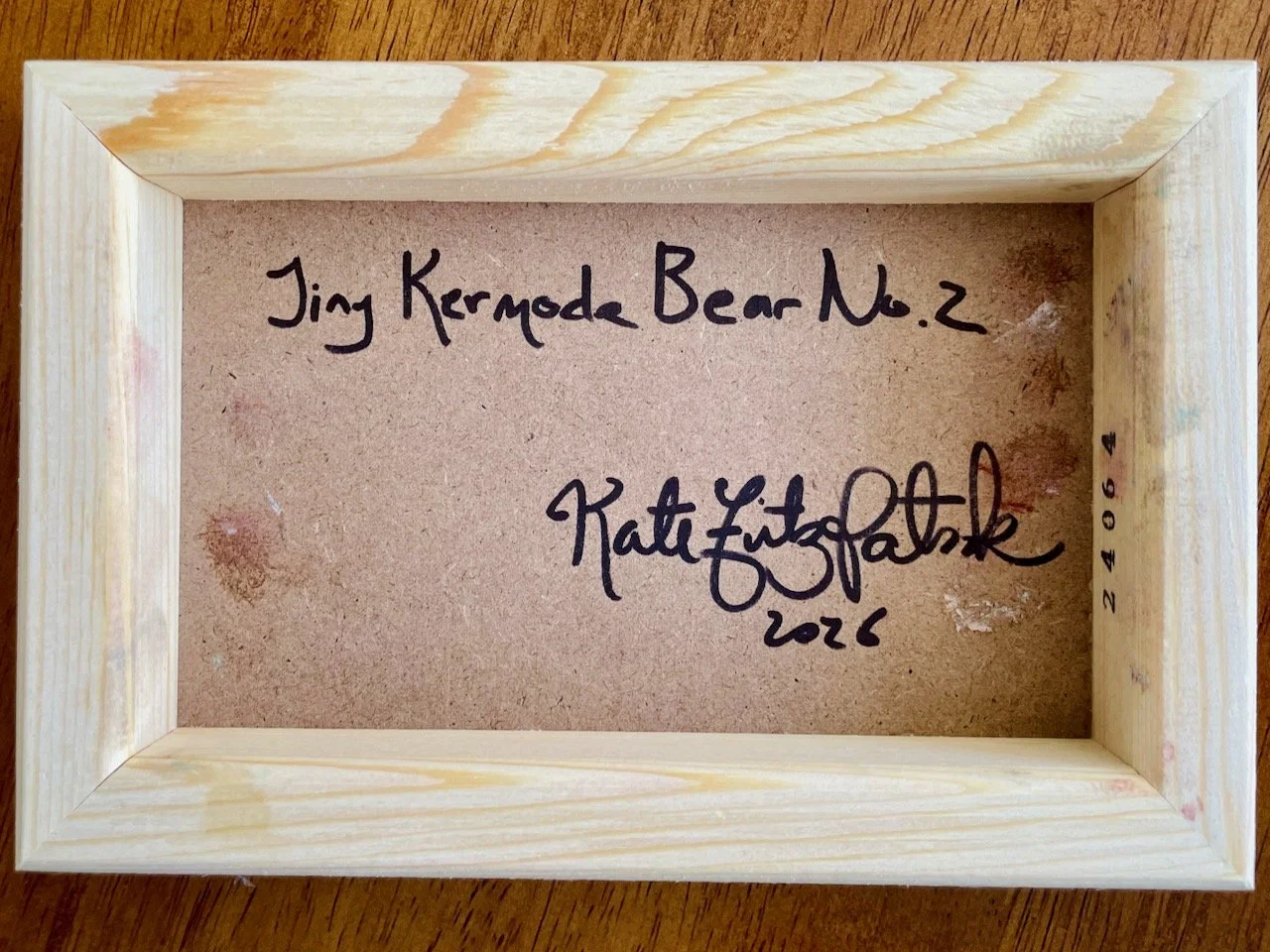 back of canvas with handwriting that reads tiny kermode bear no.2  kate fitzpatrick 2026