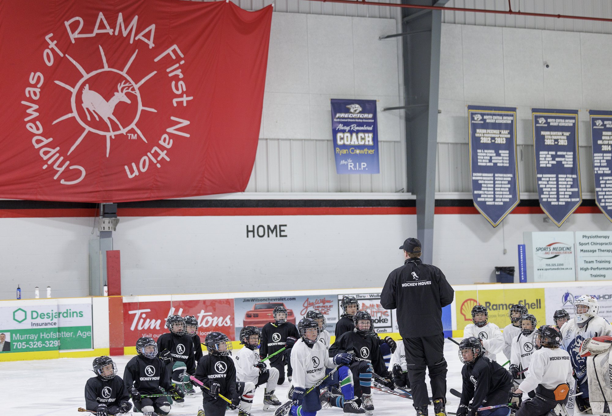 Coach Jake talks to Hockey Moves campers 