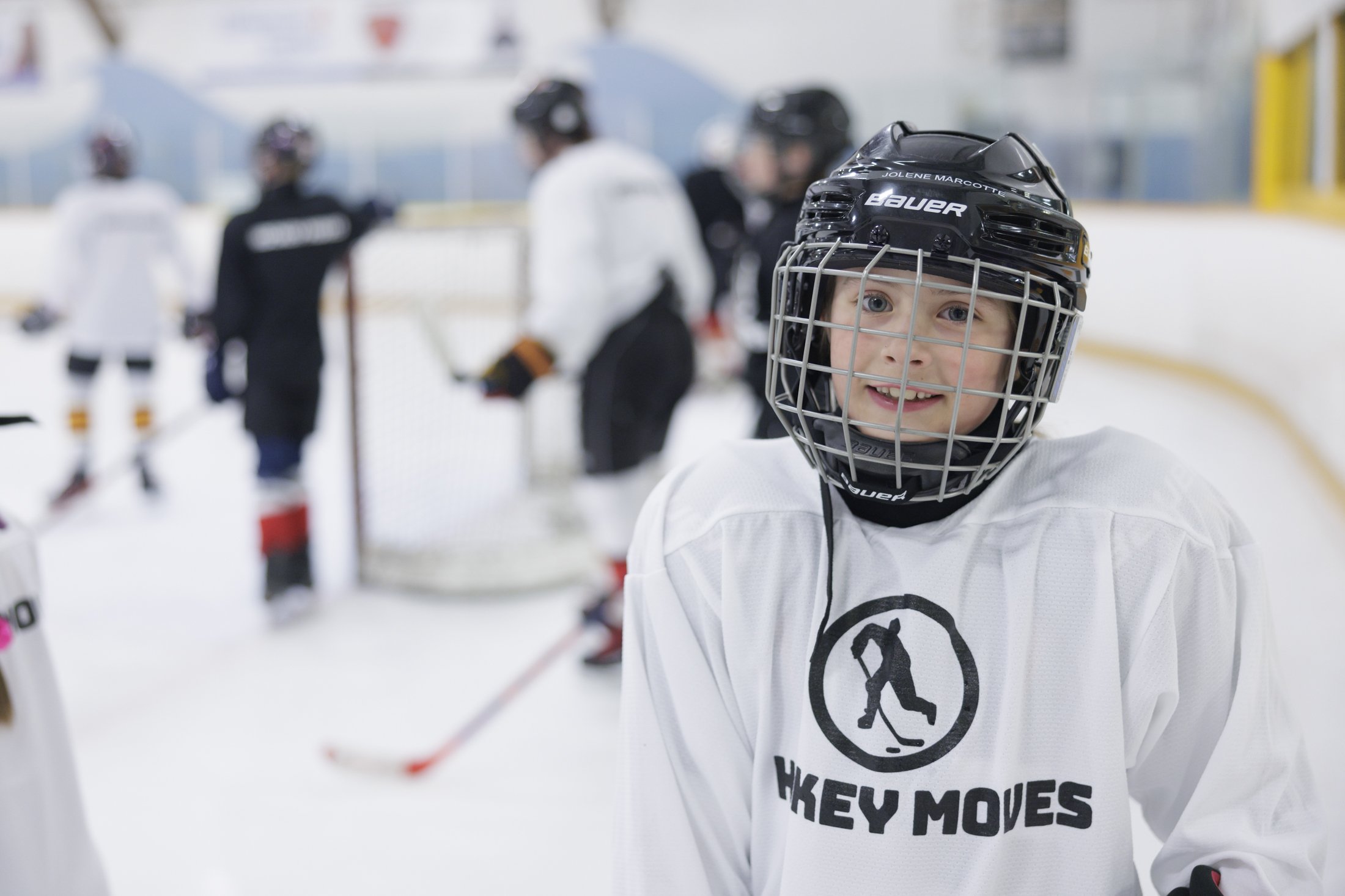 Young Hockey Moves camper smiles for the camera