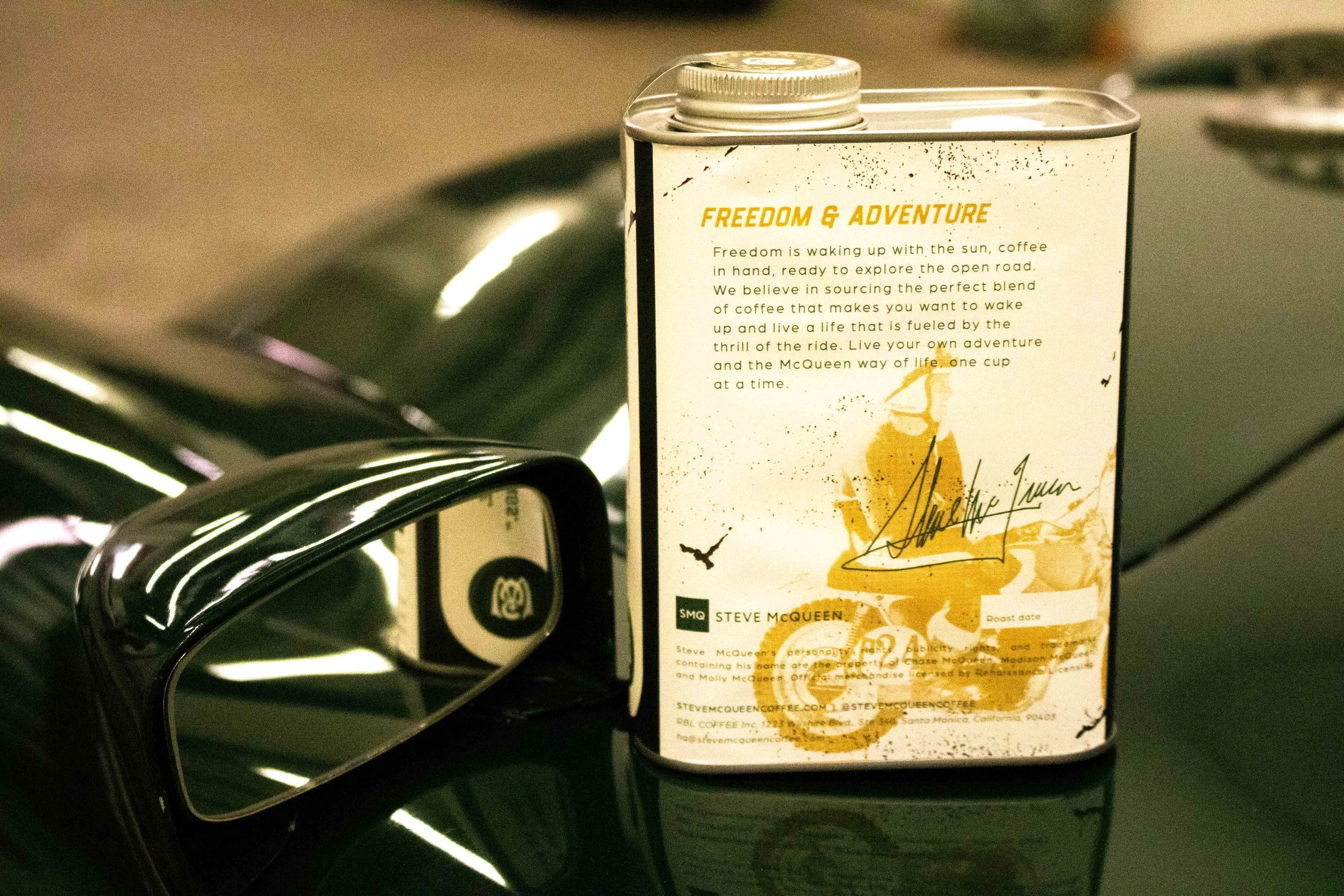 Steve McQueen Coffee tin back panel showing brand story text on vintage car hood
