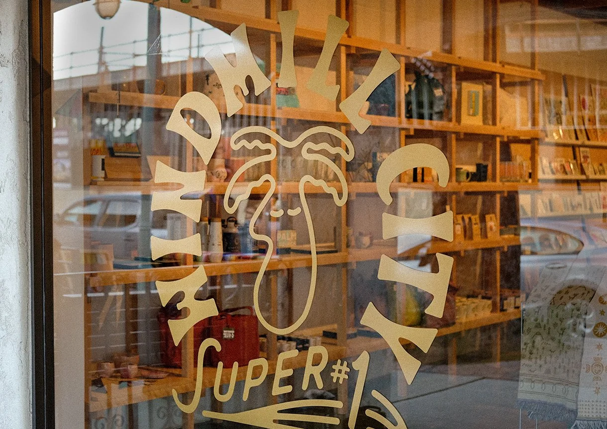 Storefront branded signage for Windmill City Super #1 Palm Springs gift shop