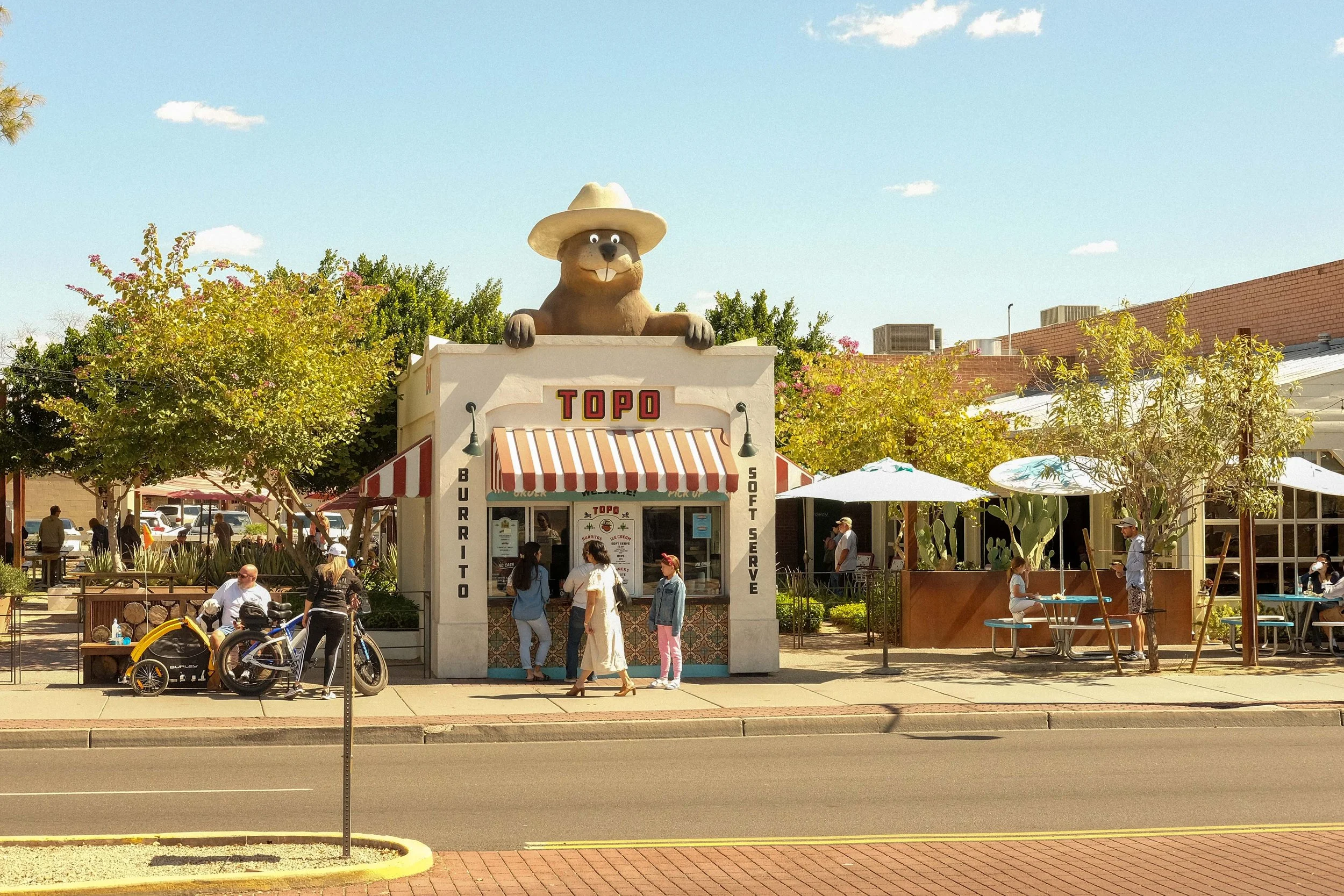 Topo restaurant front featuring menu design, branding, and signage