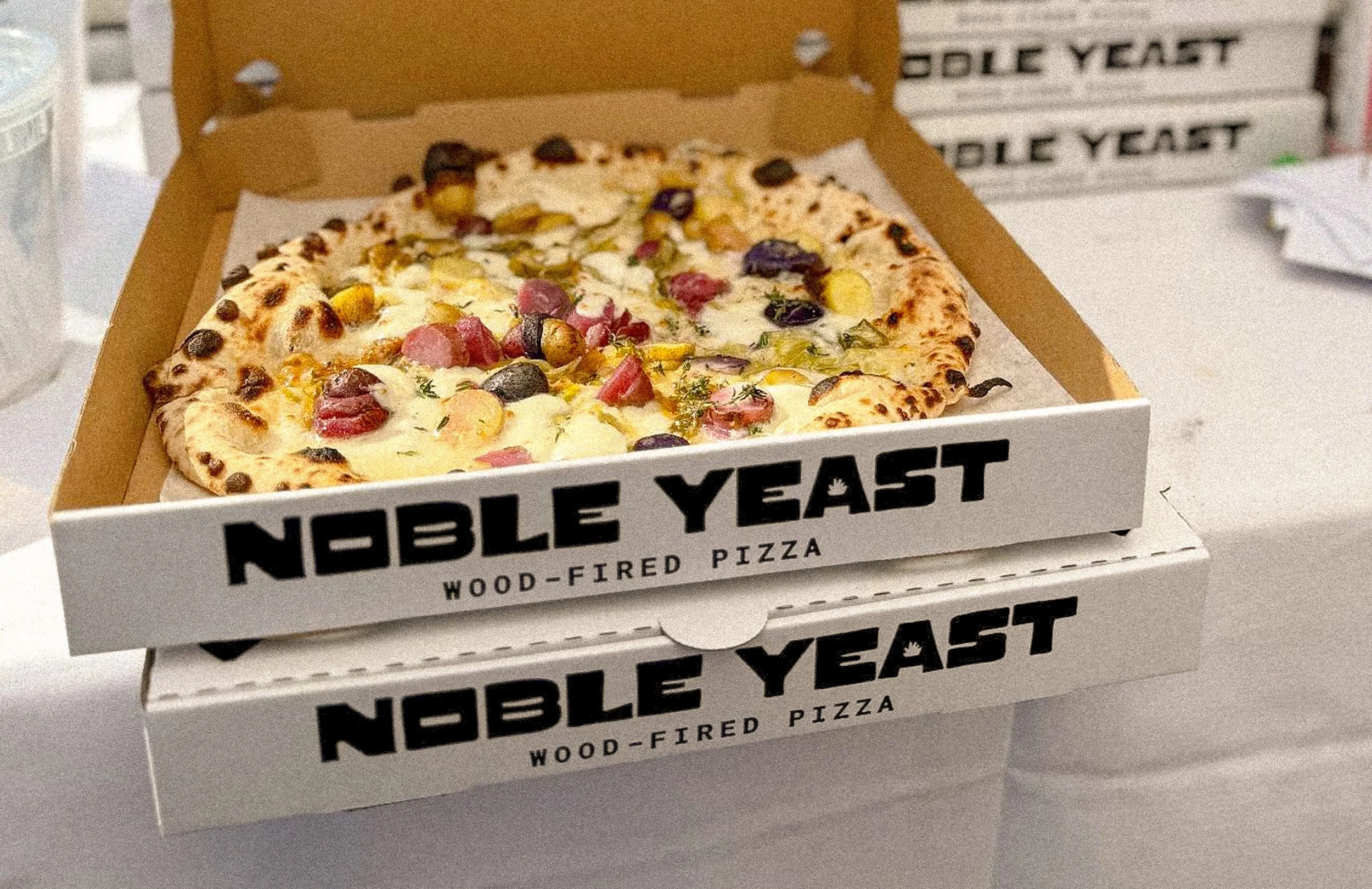 Branded pizza box logo detail for Noble Yeast