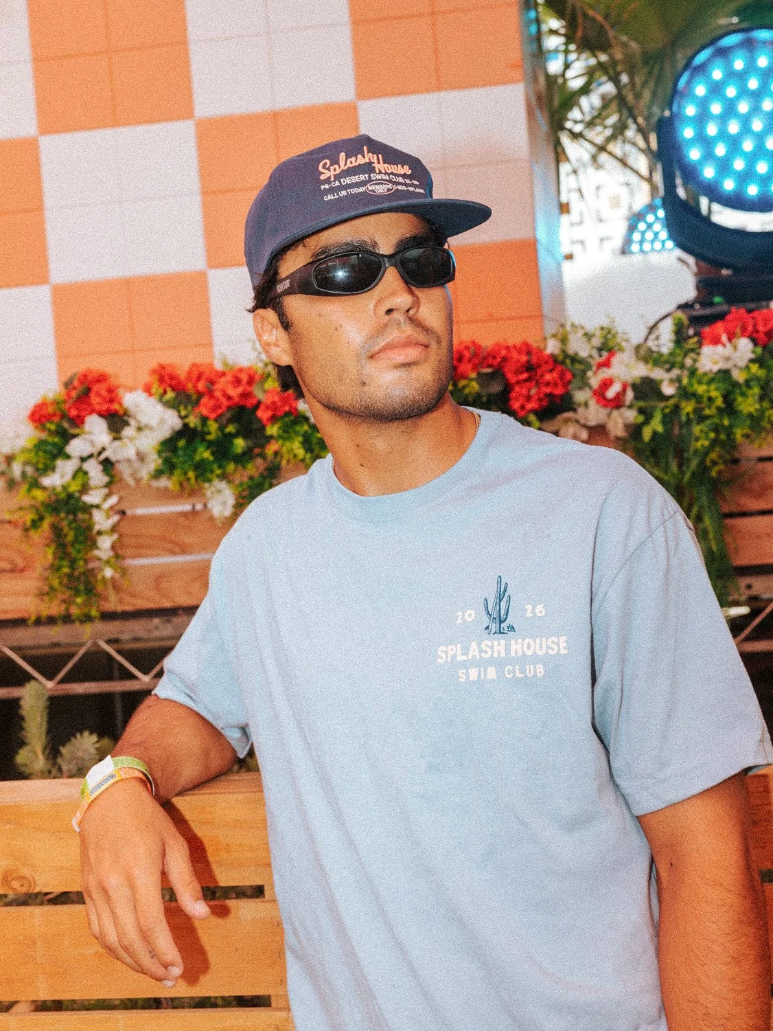 Splash House 2026 merch collection, man wearing swim club shirt and embroidered hat.