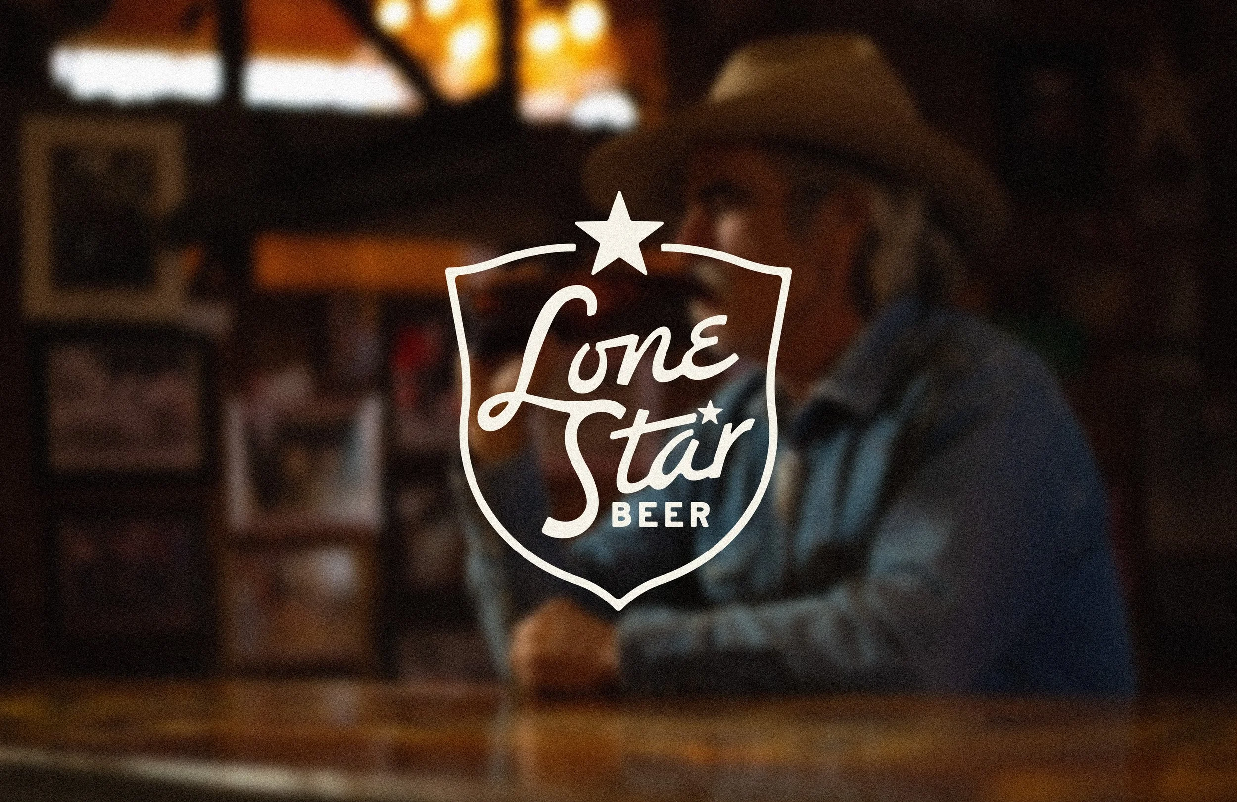 Lone Star Beer classic shield script logo design over dive bar image with cowboy