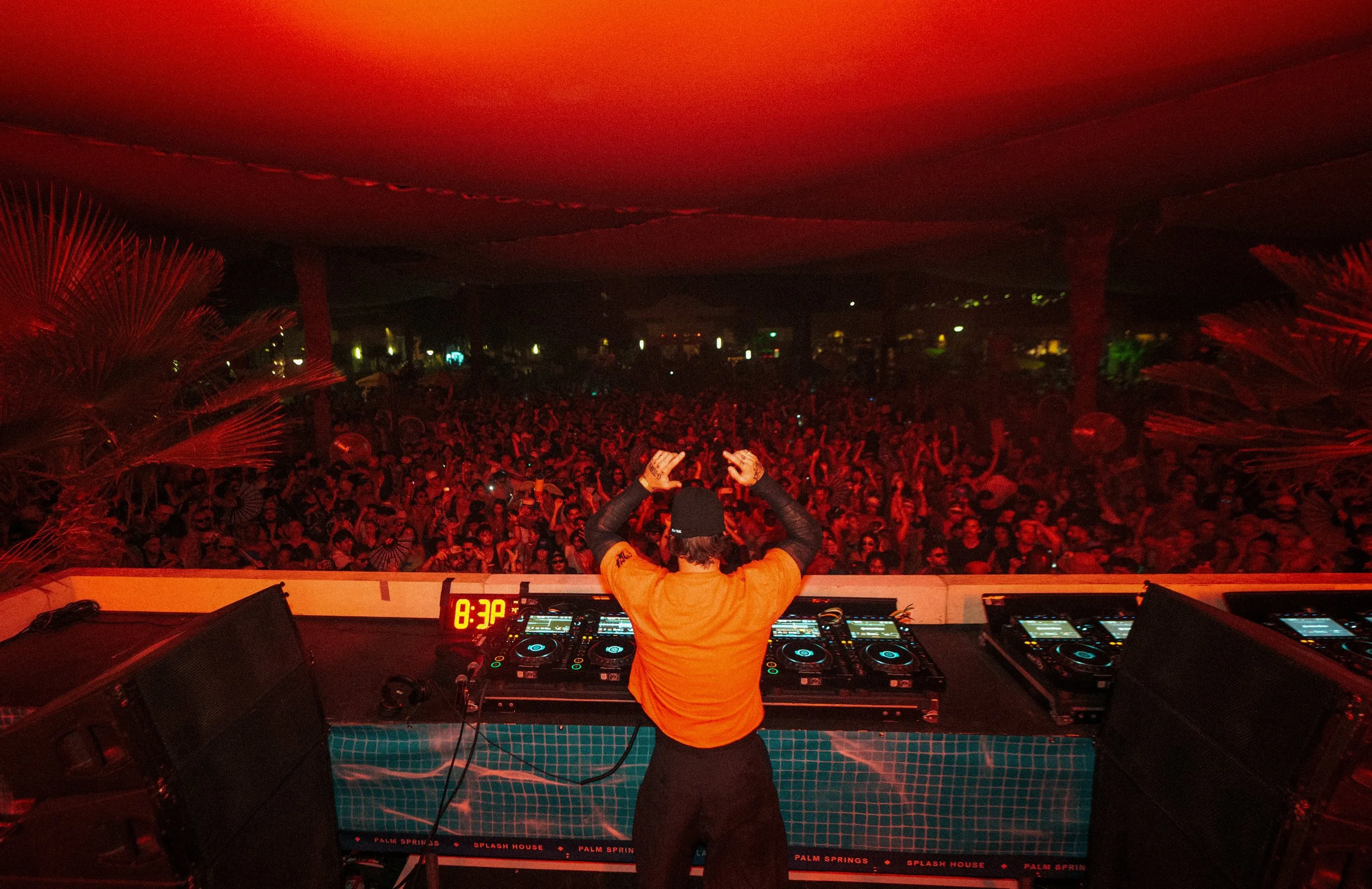 Night DJ playing set for pool party at Splash House music festival.