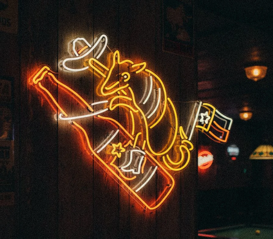 Vintage neon sign illustration design featuring a bucking armadillo on a beer bottle for Lone Star Beer merch collection in Austin Texas dive bar