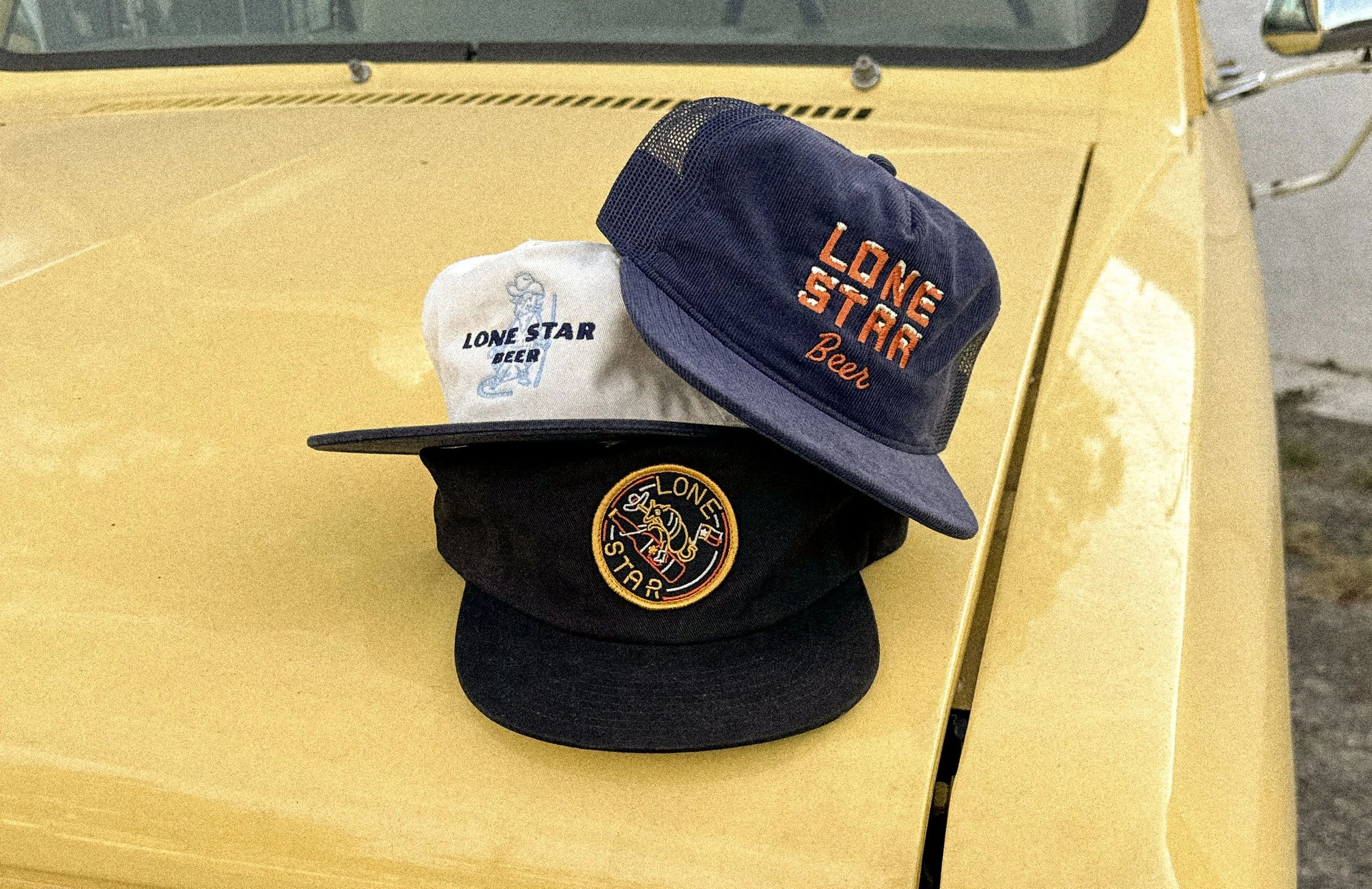 Lone Star Beer embroidered hat collection showing multiple merch designs"