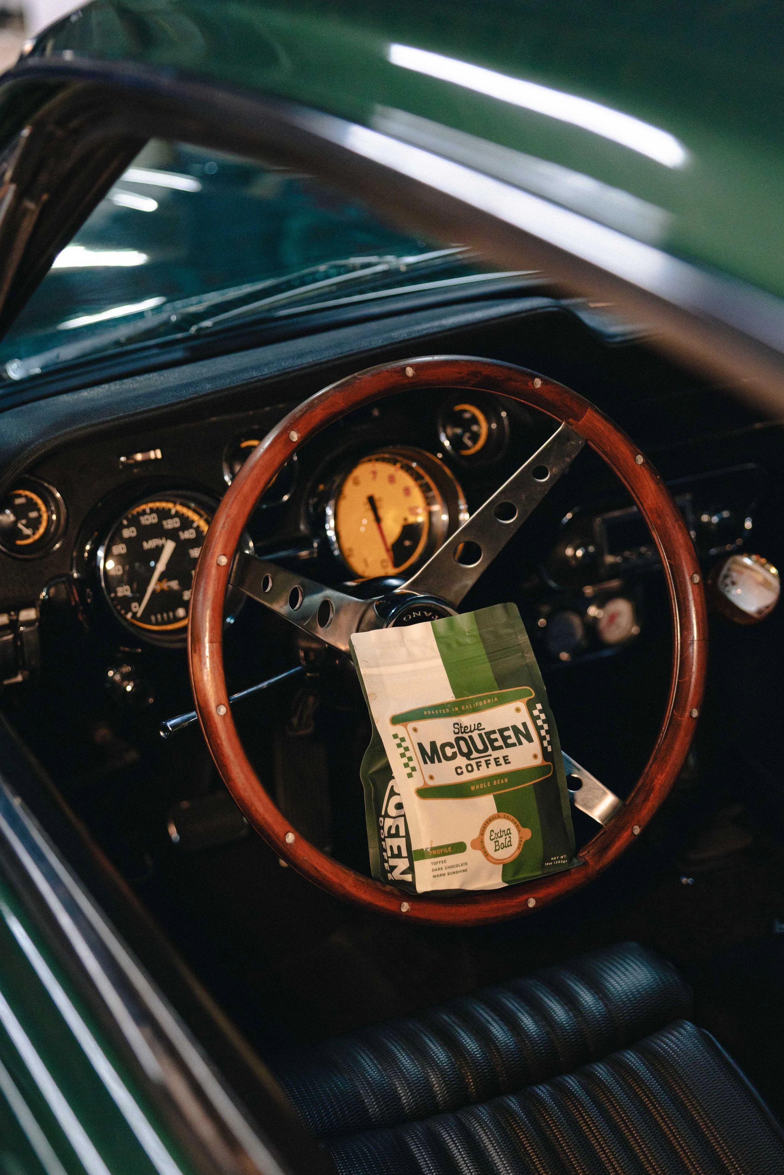 Steve McQueen Coffee pouch packaging styled with vintage automotive elements on vintage car steering wheel