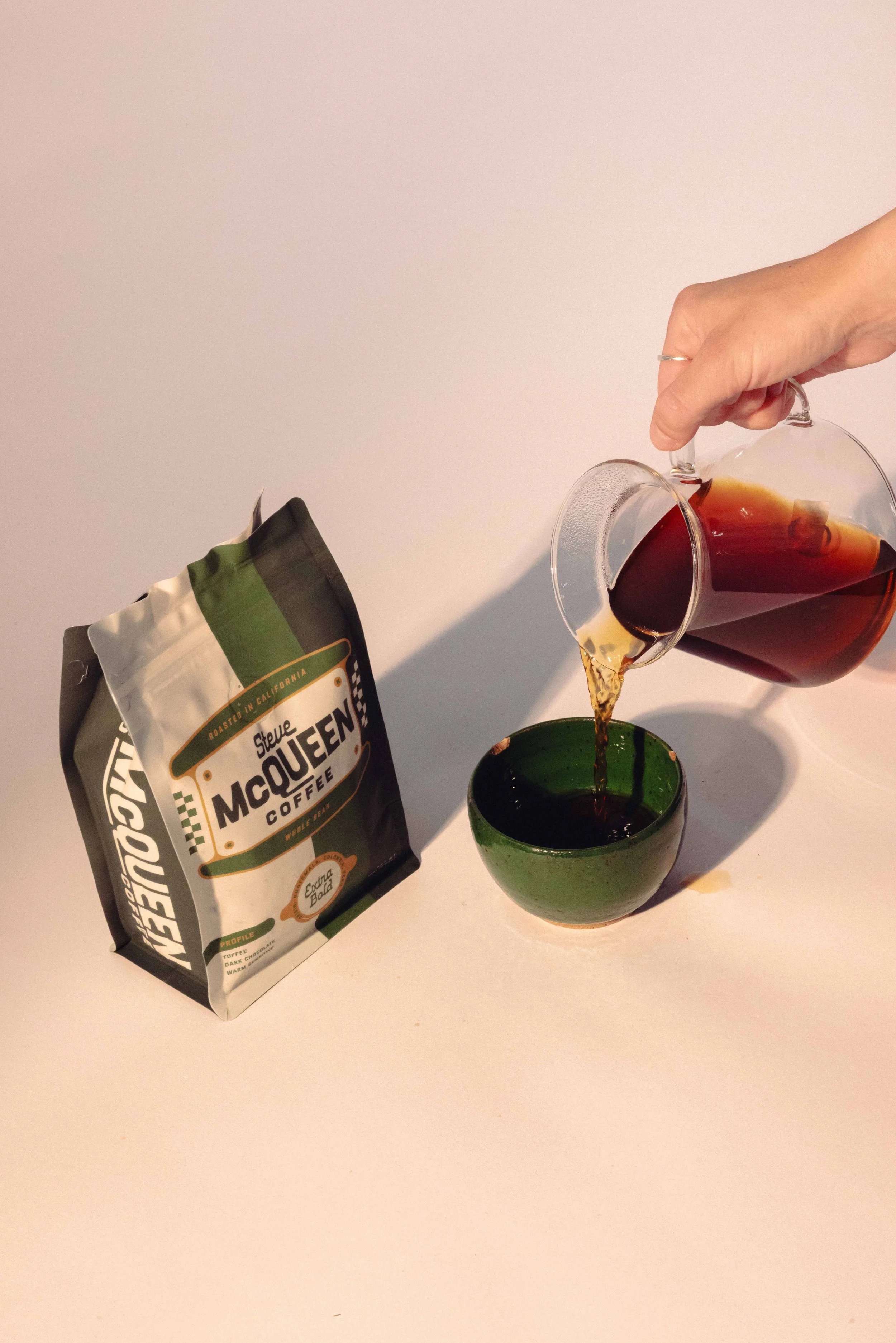 Craft coffee bag packaging featuring Steve McQueen brand identity being poured into cup