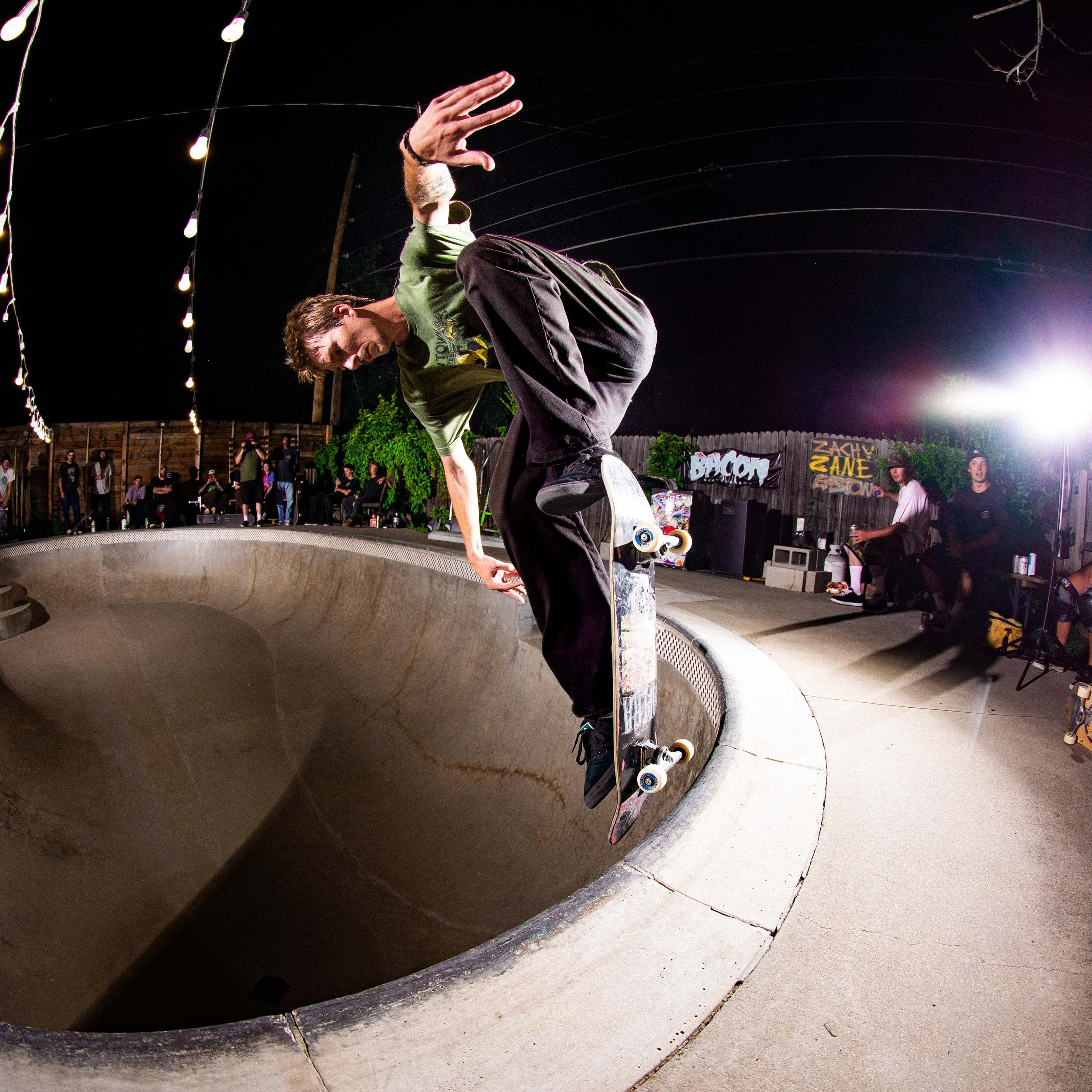 Cowtown rider Nick Papa performing a noseblunt in pool wearing Cowtown store merch