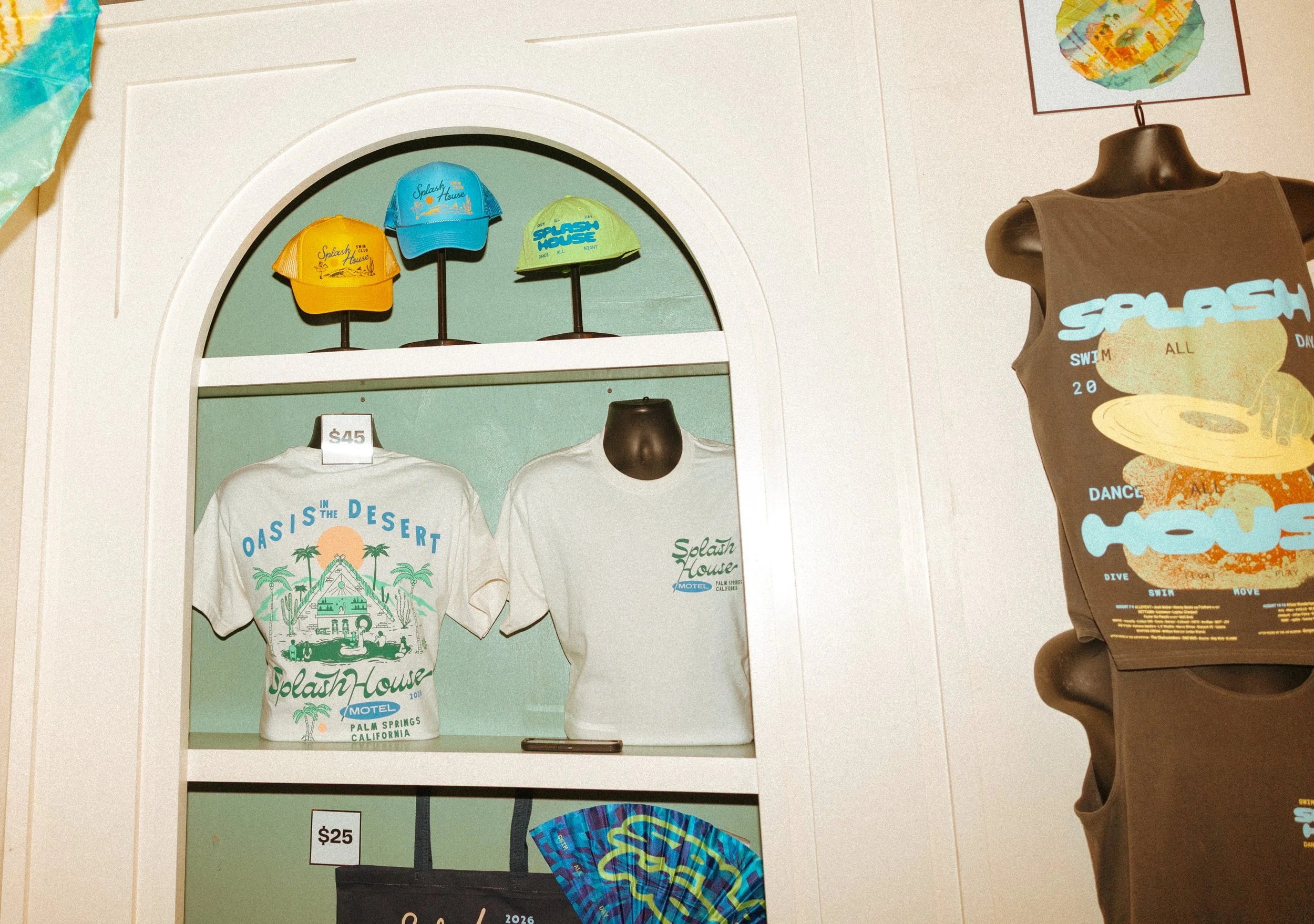 Shirt, trucker hat, and bucket hat display for Splash House merch collection graphics.