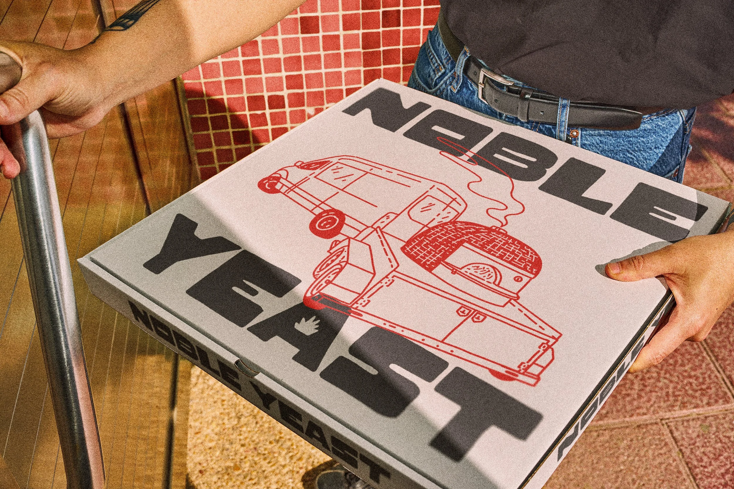 Noble Yeast takeout box design featuring hand drawn van and trailer illustration with primary branding
