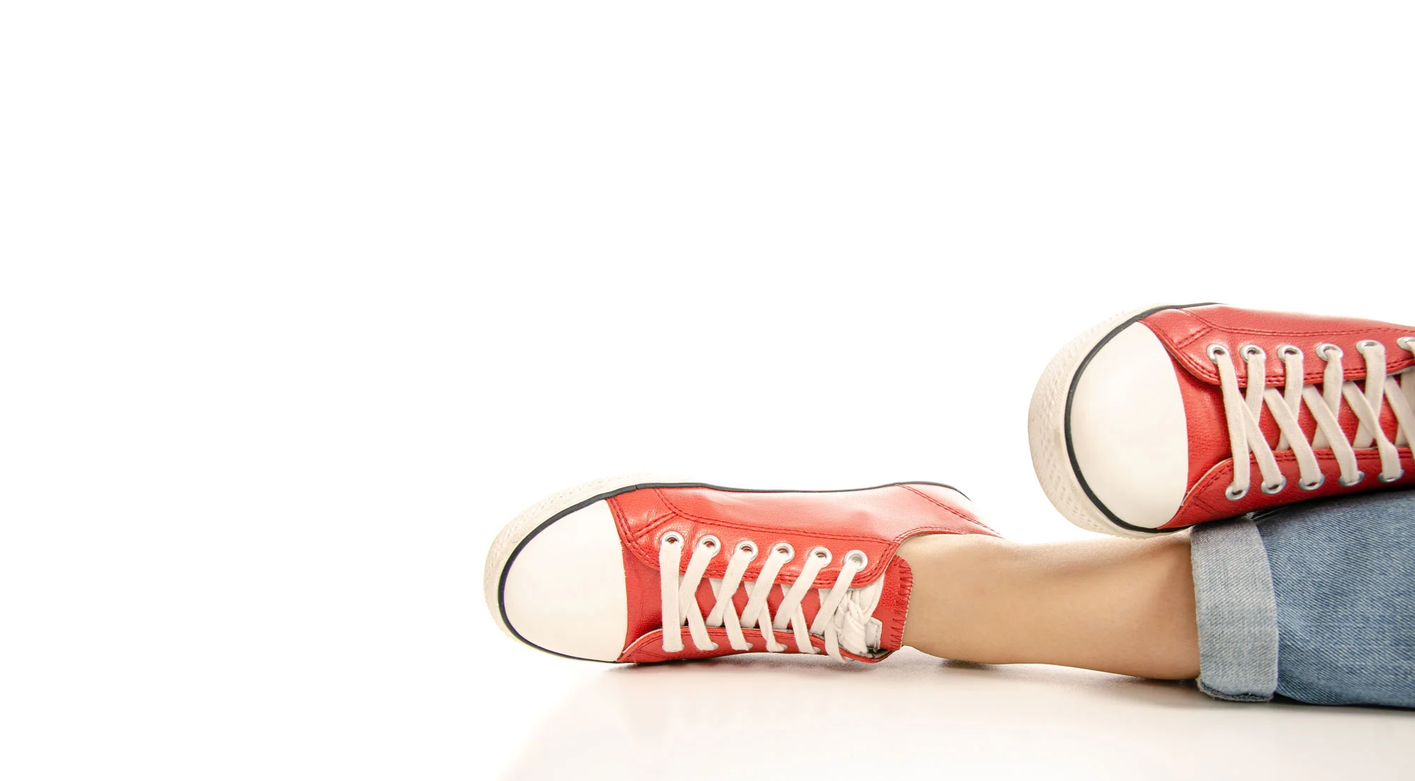 bigstock-Woman-Legs-Feet-Jeans-Red-Snea-275623621edit.jpg