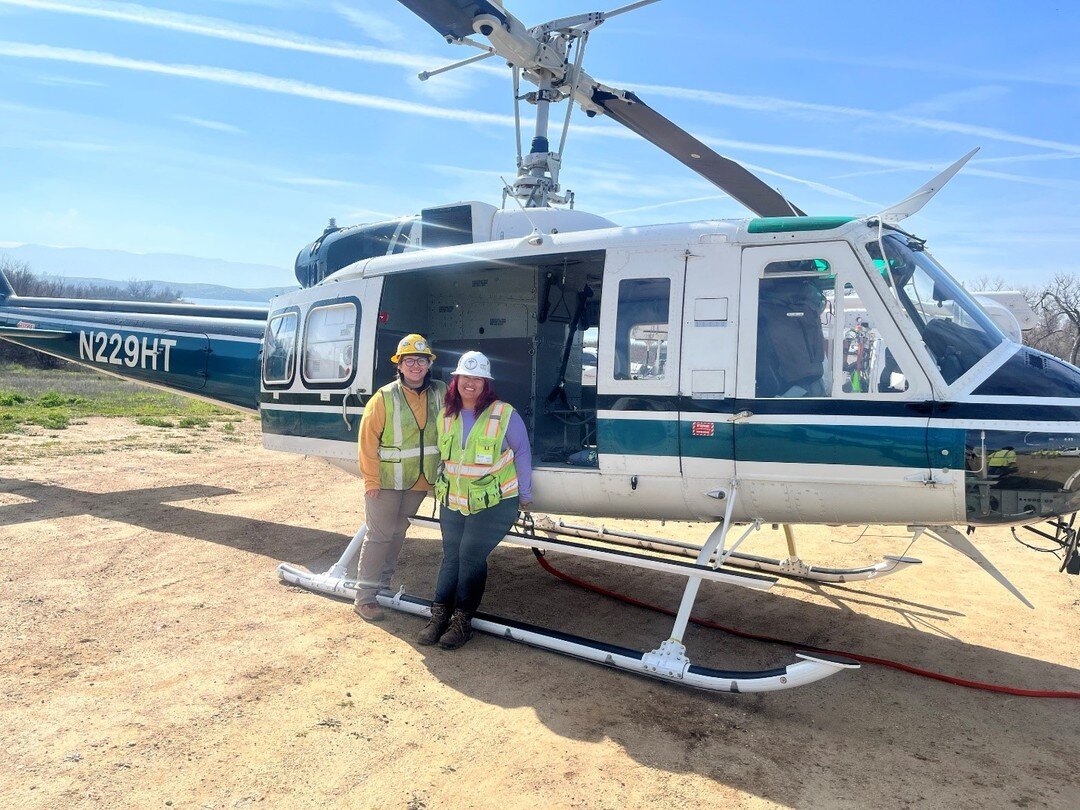 Field Work Friday! Pax Biologists Ariana Dorticos and Marielle Medina pose with a helicopter after monitoring a successful pole replacement! 
#paxenvironmental #environmentalconsulting #fieldmonitoring #surveying #hiringnow #jobsearch #bestplacetowor