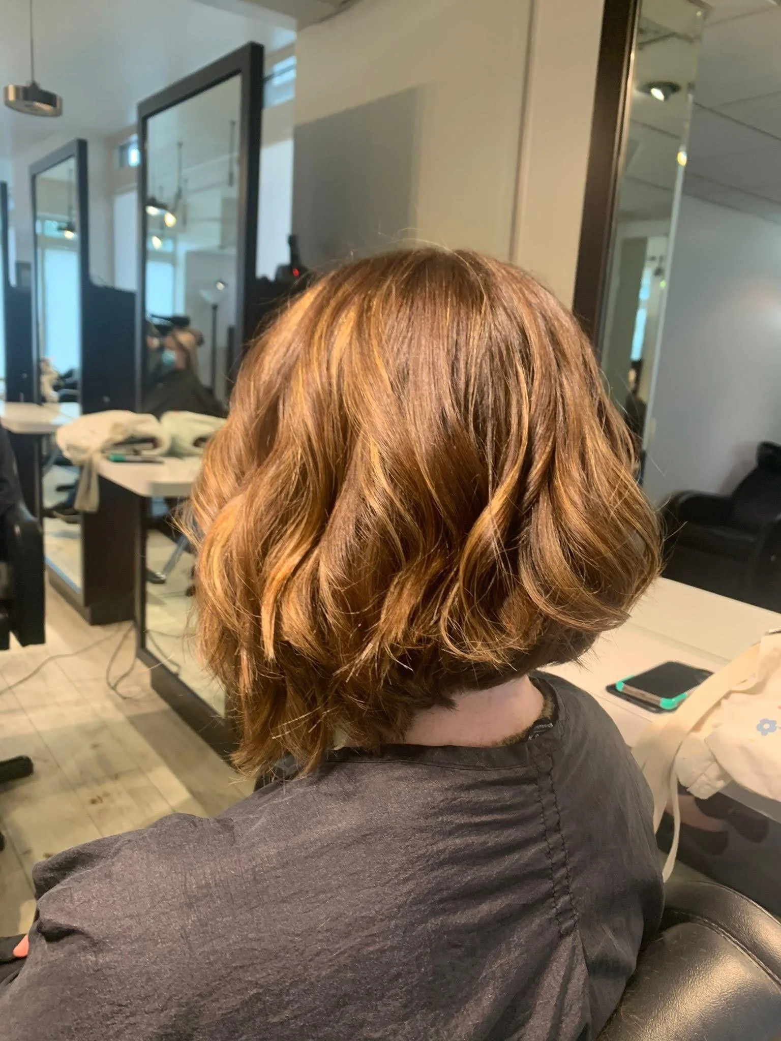 Warm copper auburn hair color with dimensional shine at Salon Sonik