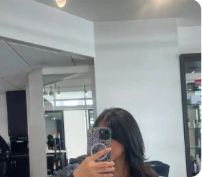 Client with fresh bob haircut and bangs taking a mirror selfie at Salon Sonik in Pasadena