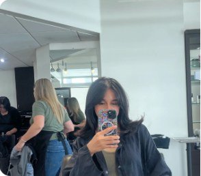 Client with fresh bob haircut and bangs taking a mirror selfie at Salon Sonik in Pasadena