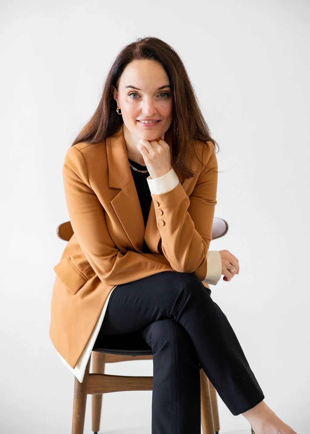 portrait photography of woman wearing a tan jacket and black pants