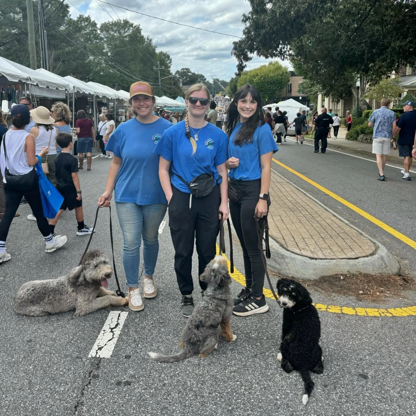 Great day for socialization and leash work here at ADT! 🐾
Our board &amp; train dogs Bo, Doc, and Wyatt got to head out for a real-world training session since Crabapple Fest was right down the street! 🎡 Lots of excitement, people, and distractions