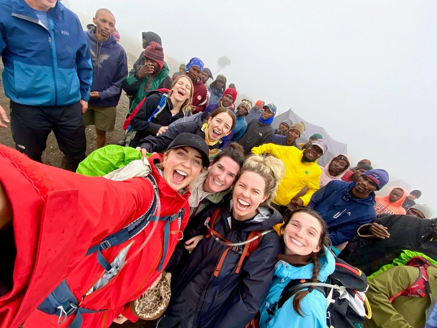 Smiles this big in the rain can only mean one thing&mdash;you&rsquo;re on the trip of a lifetime. 🌍✨