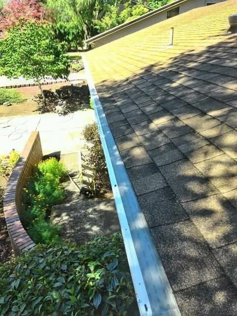 Gutter guard installation after a deep gutter cleaning.