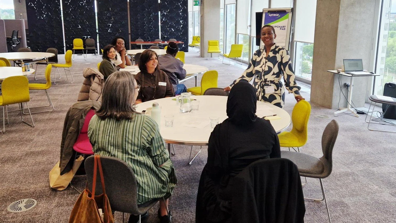 Leadership facilitator leading an interactive leadership development workshop with emerging leaders in a collaborative learning environment.