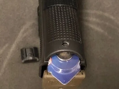 With a little trimming the battery package will fit in the deadspace behind the mag well of the Glock pistols.