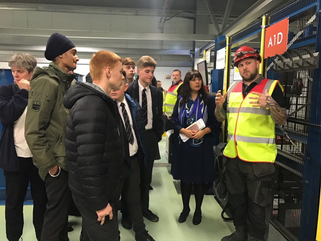 Ms Ghani and Rawlett School students learning about the pallet storage system