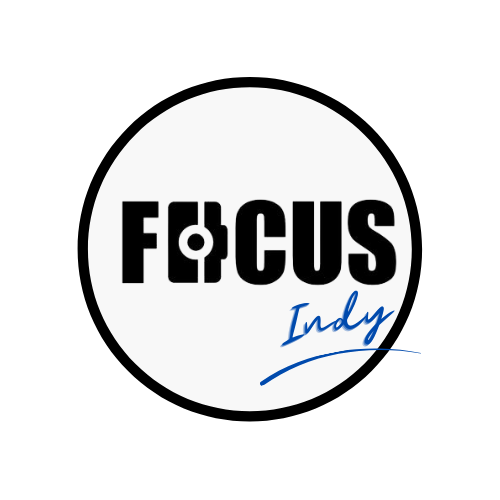 Logo with the word 'FOCUS' in bold black letters and 'Indy' in blue script, on a white circular background.