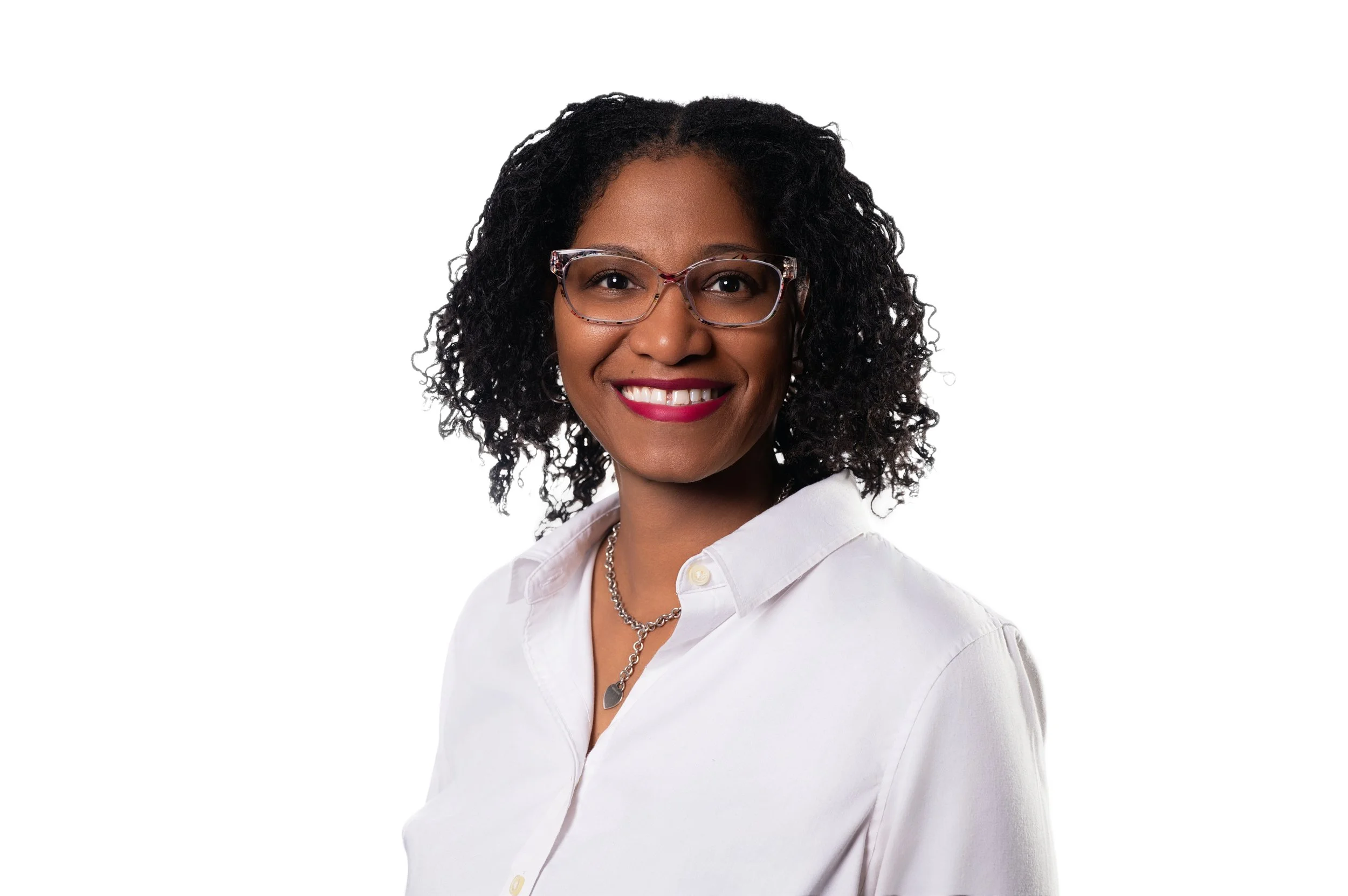 Person wearing glasses and a white shirt smiling against a white background.
