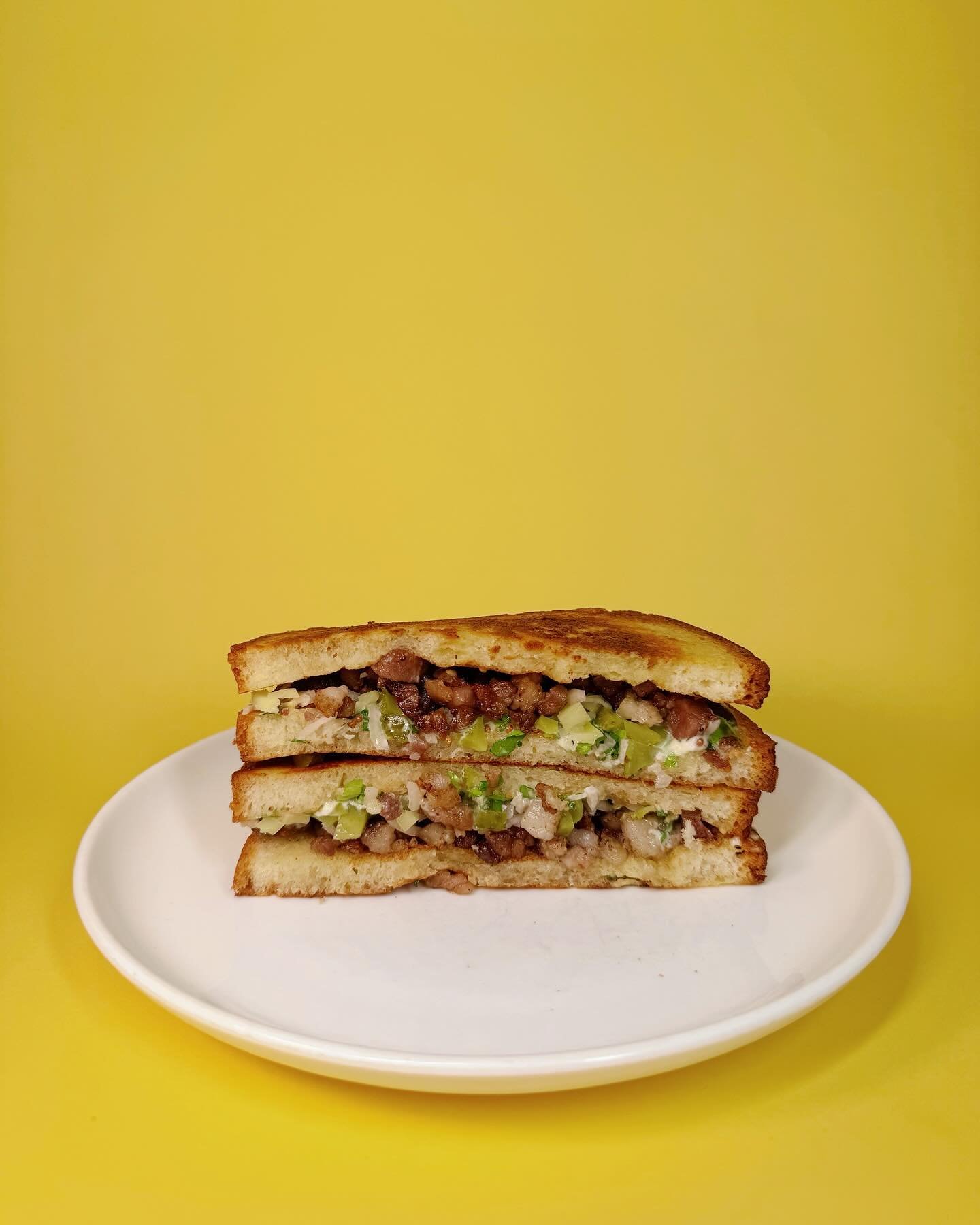 Pigs Head Sandwich - slow cooked pig&rsquo;s head crisped up in the plancha, cornichon, grainy mustard and celery leaves.