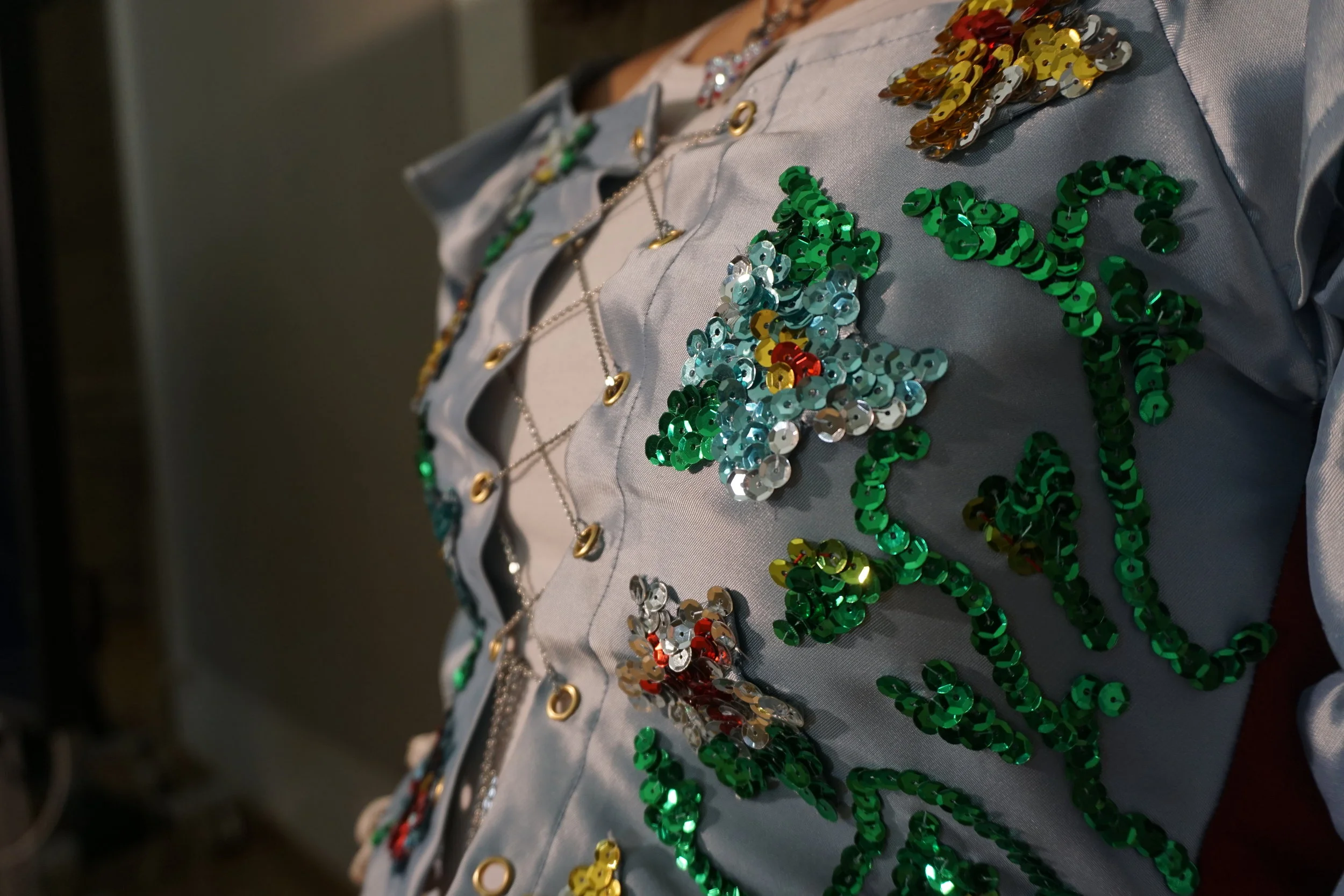 detail. satin, metal chain, sequins, grommets