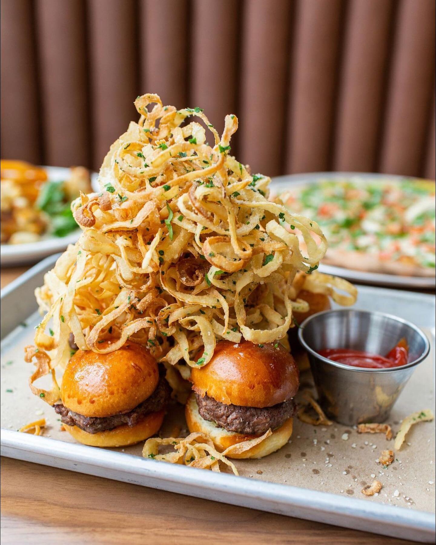 A starter you shouldn't miss out on.  In frame:  our 3.6.9. mini burgers, stacked high with onion straws.  Who&rsquo;d be down to share this with you?