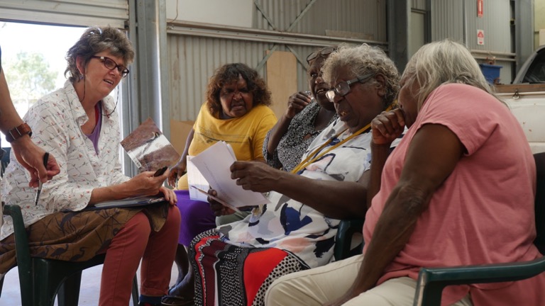 Enjoying each other’s company and the flexibility to work indoors or outdoors helps in facilitation. Wiluna women identify the bird species they want school students to study in 2018. (By David Nixon)