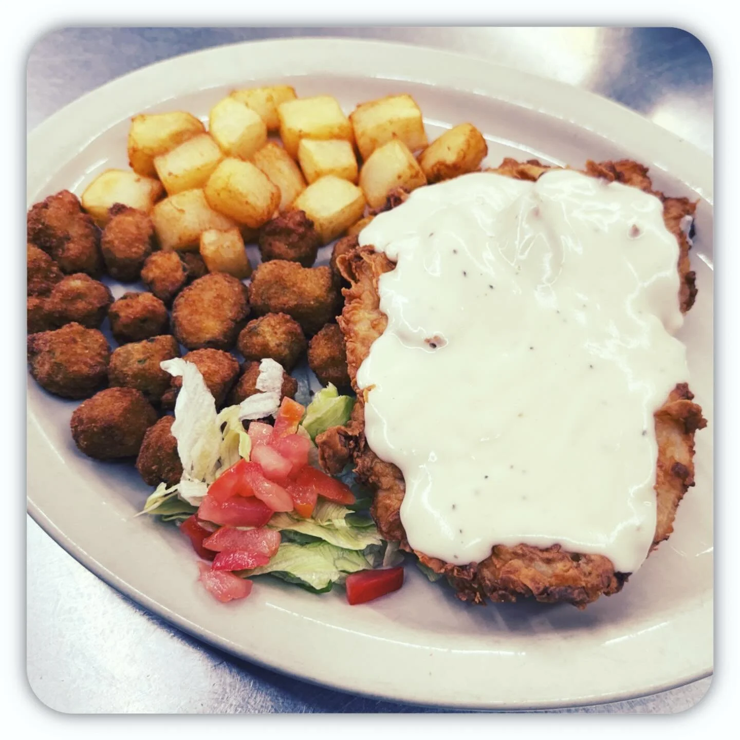 🍽️ Crispy, Creamy, Completely Irresistible 🍽️

Sink your fork into golden, crispy-fried perfection topped with a rich, velvety white gravy that melts into every bite. Paired with potato cubes or fries, and crunchy okra. 

🔥 Comfort food done right