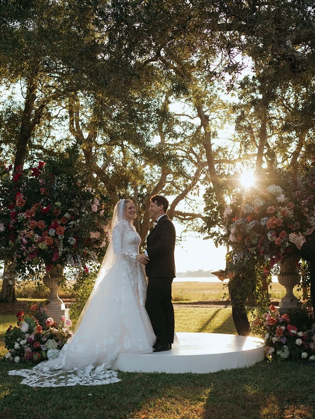 Ceremony moments during golden hour with the most magnificent floral urns by @blossoms_events