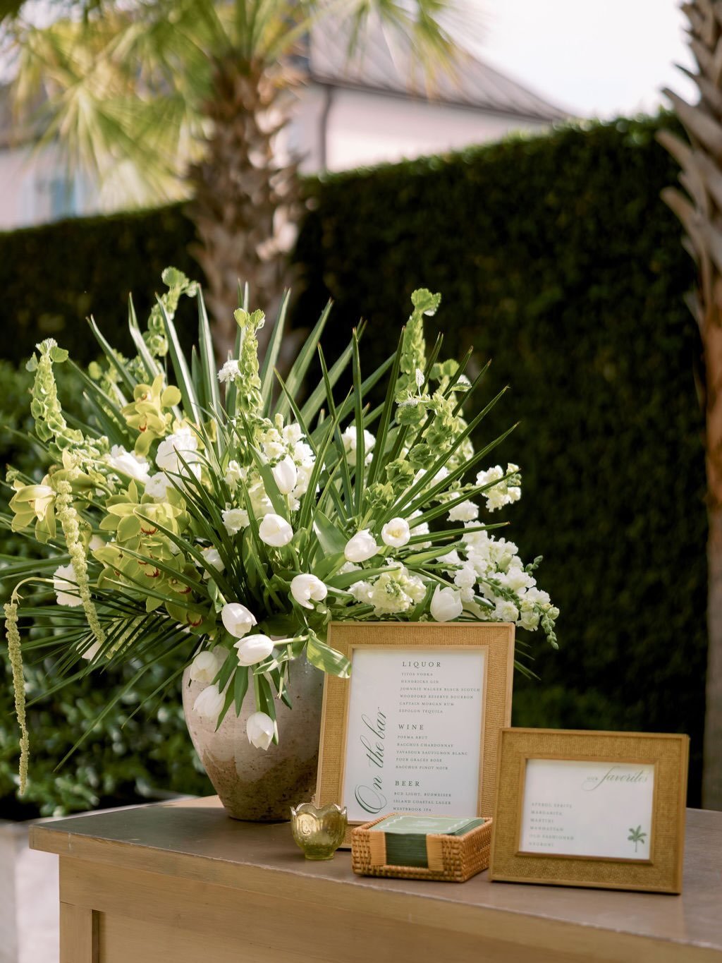 Under the palms with good company &mdash; the perfect way to kick off the big weekend for Lizzy and Ryan 🤍
.
.
.
Photo: @shannonoleksak 
Floral: @festooncharleston 
Rentals: @curatedeventscollective 
Stationery: @kateelizacreative
Venue, Catering + 