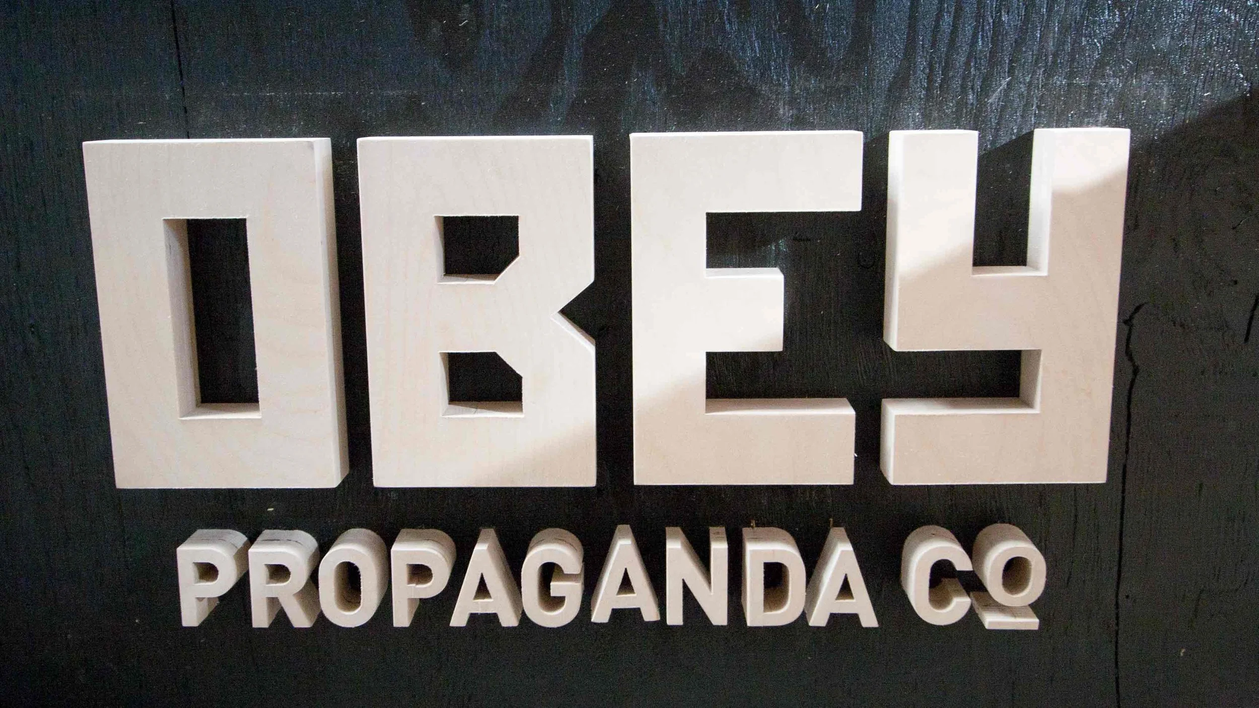 Wood sign for Obey