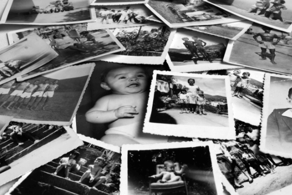 Old black and white photos in a messy pile