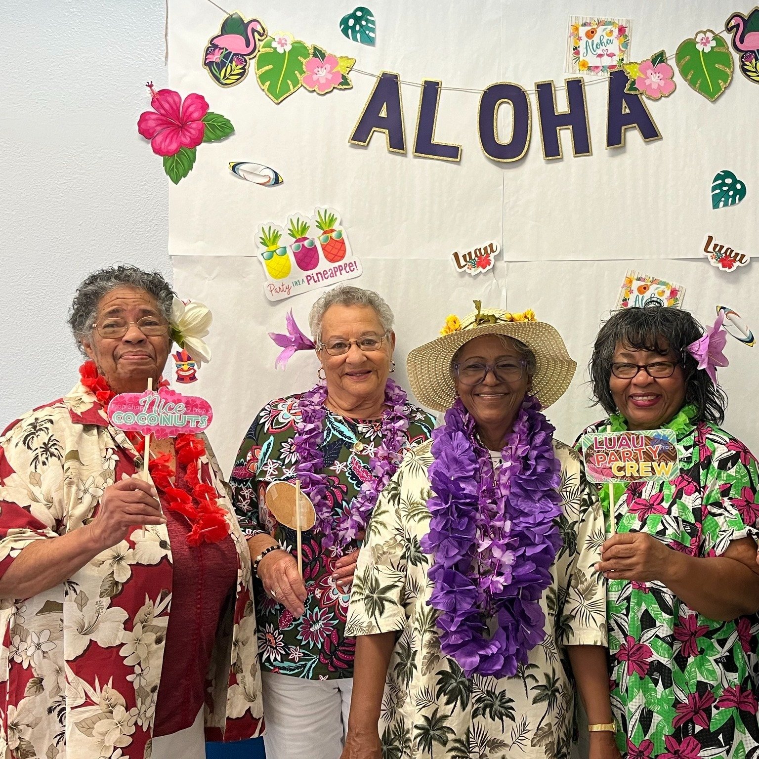group of older women at an aloha themed party