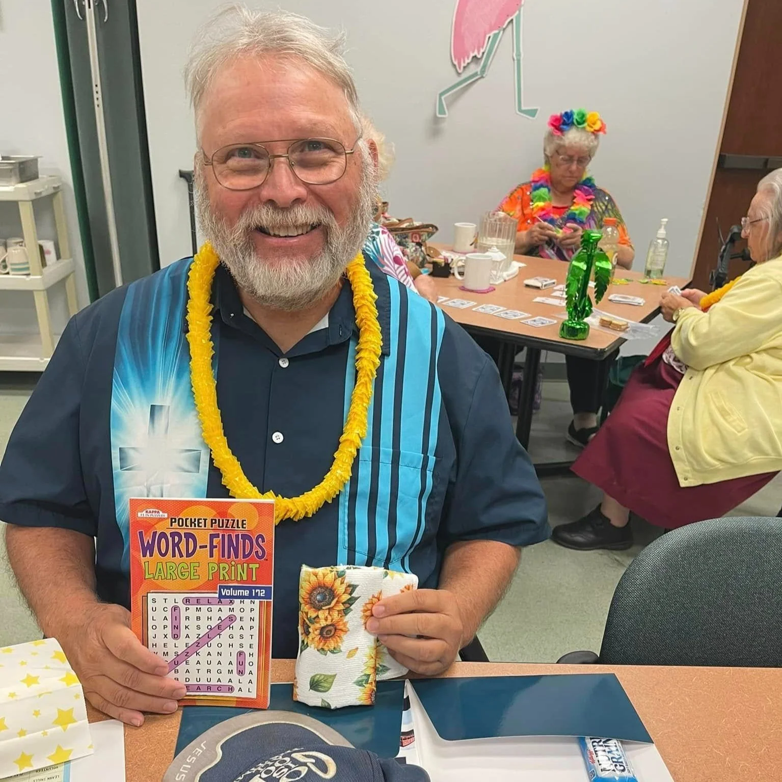 man holding up a word search smiling