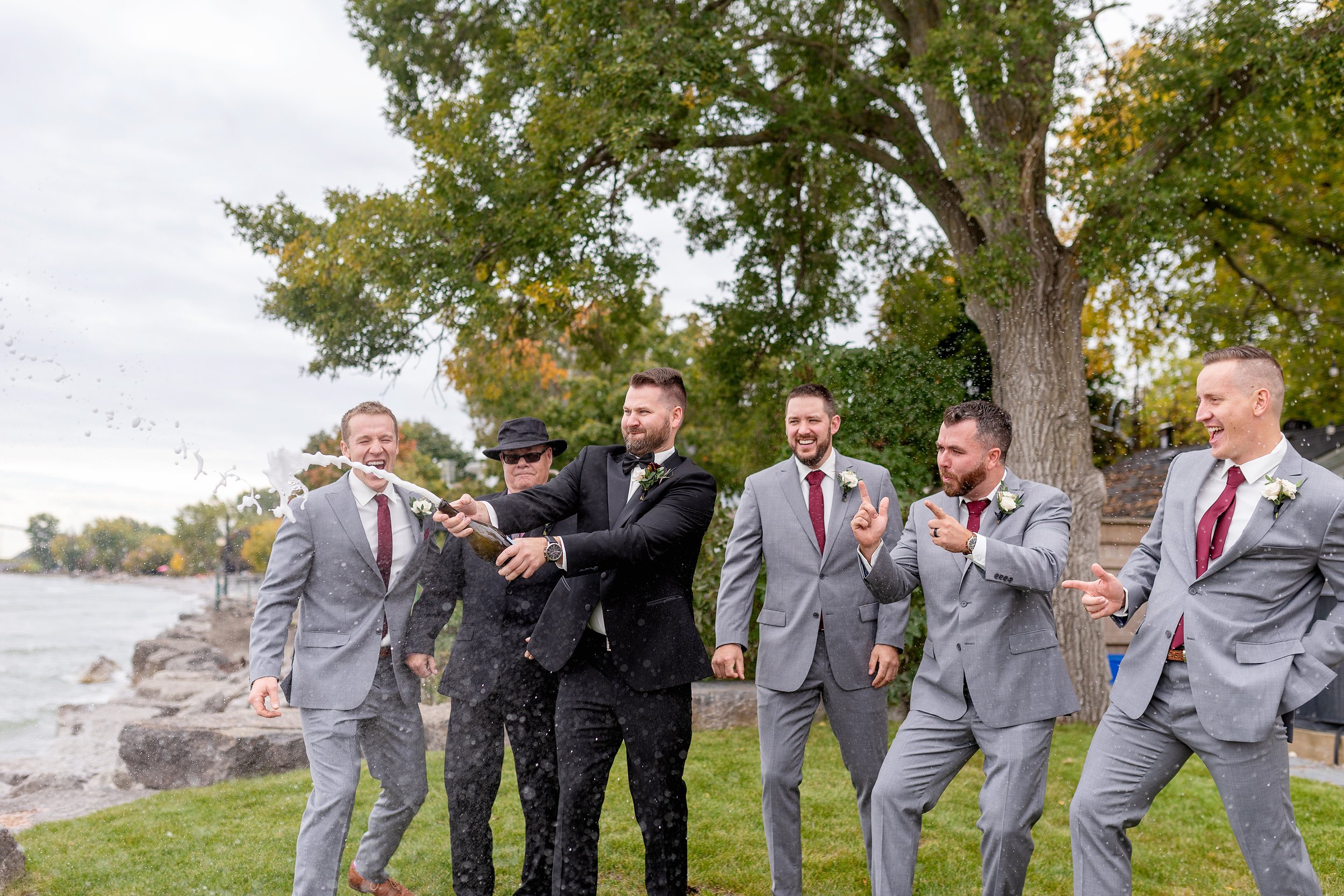 Guys popping bottles on wedding day