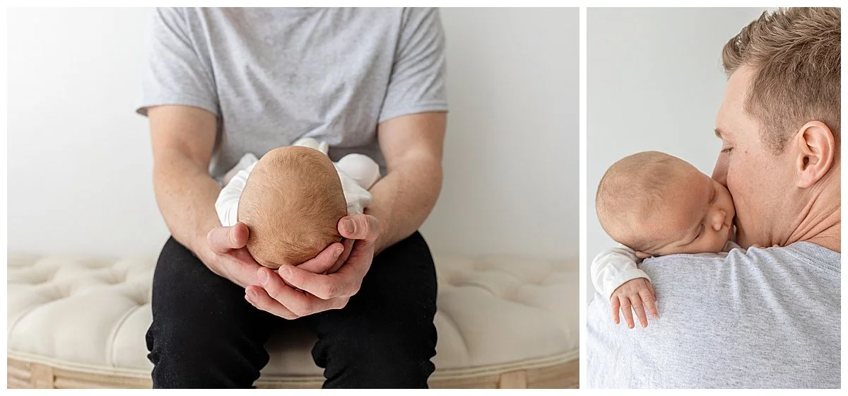 New dad sitting on a bench and holding his newborn daughter in his hands and then baby on his shoulder as he kisses her cheek, in Oshawa studio