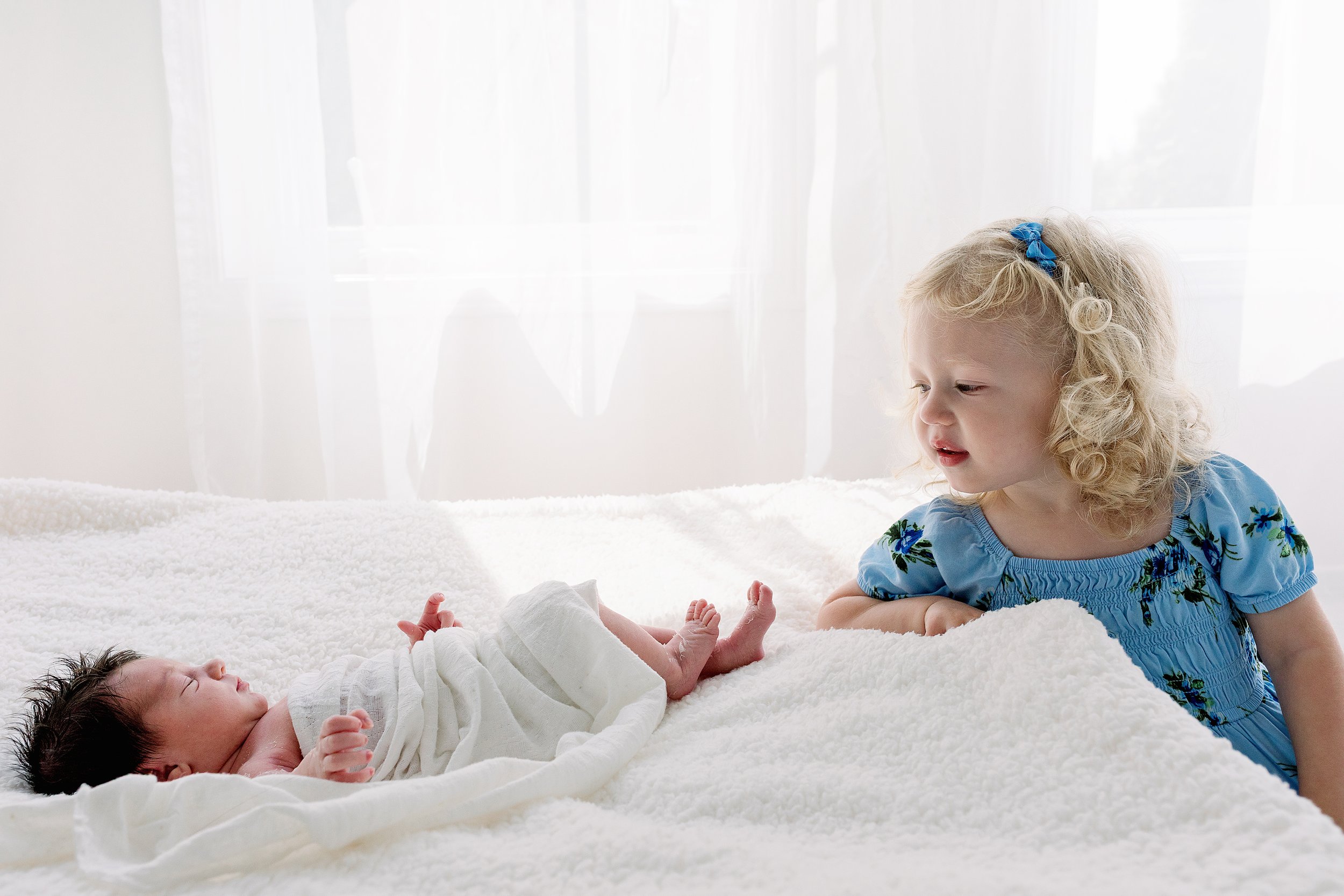Newborn session with big sister in white studio in Oshawa Durham Region
